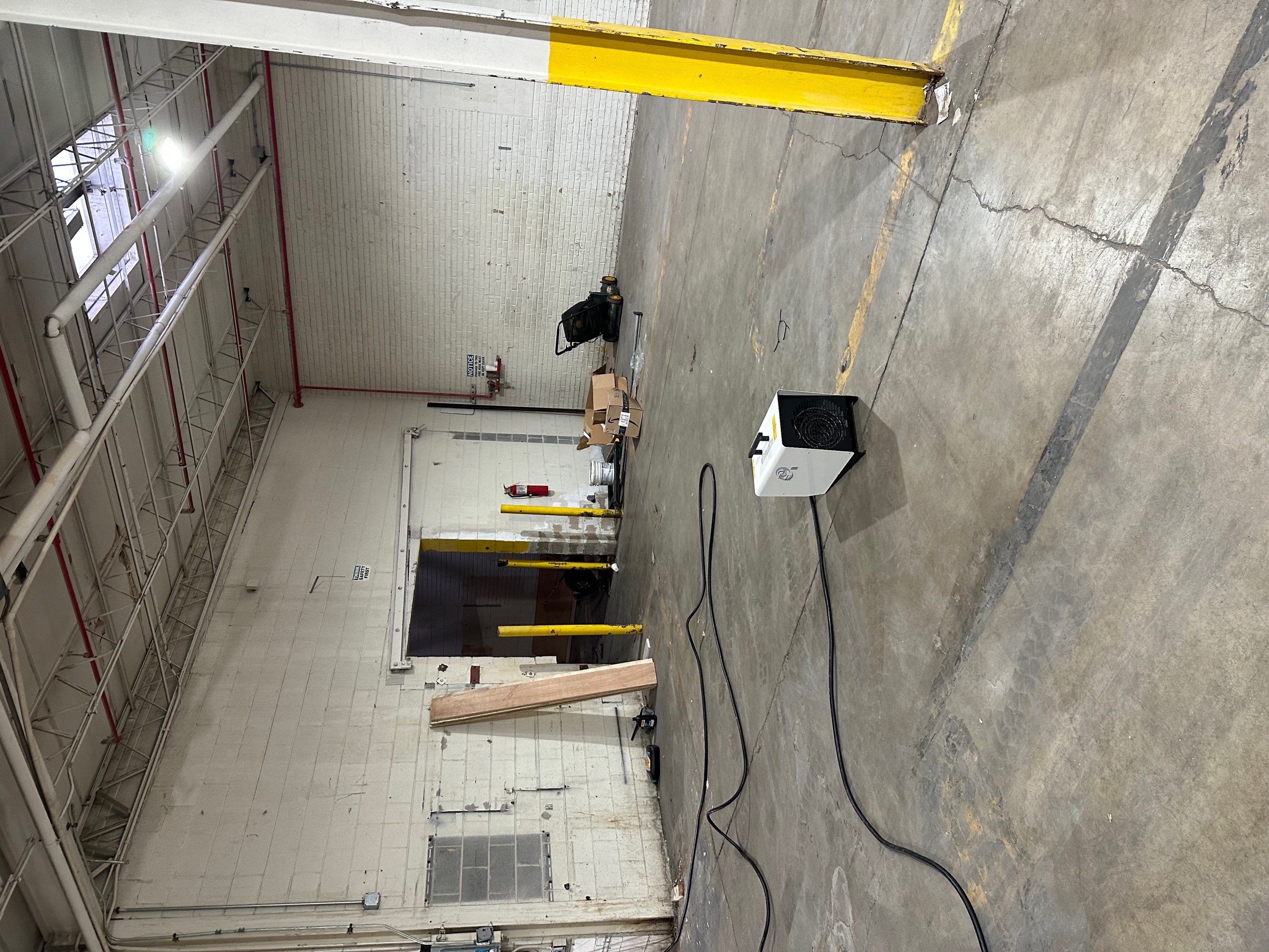 9kW Mobile Electric heater rental positioned on concrete floor connected to the electrical box. 