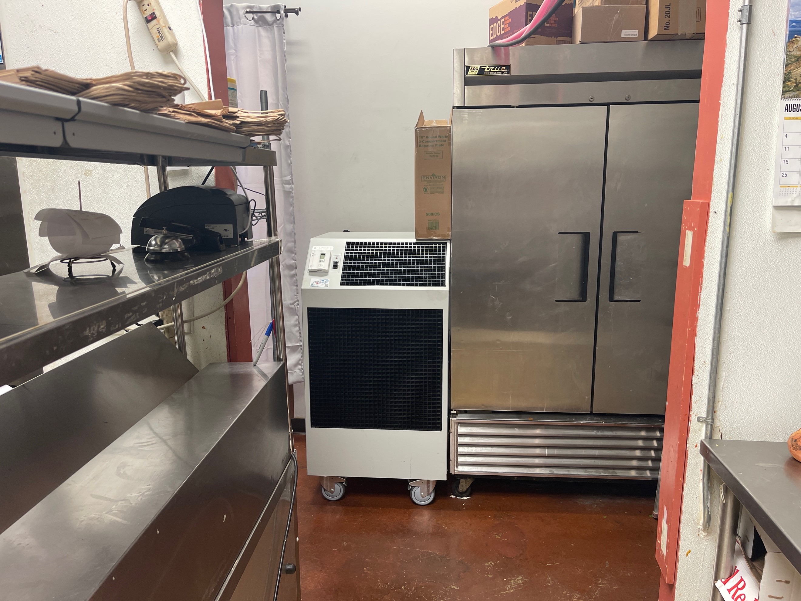 Portable Air equipment installed in fast food restaurant kitchen with water hoses routed overhead.  