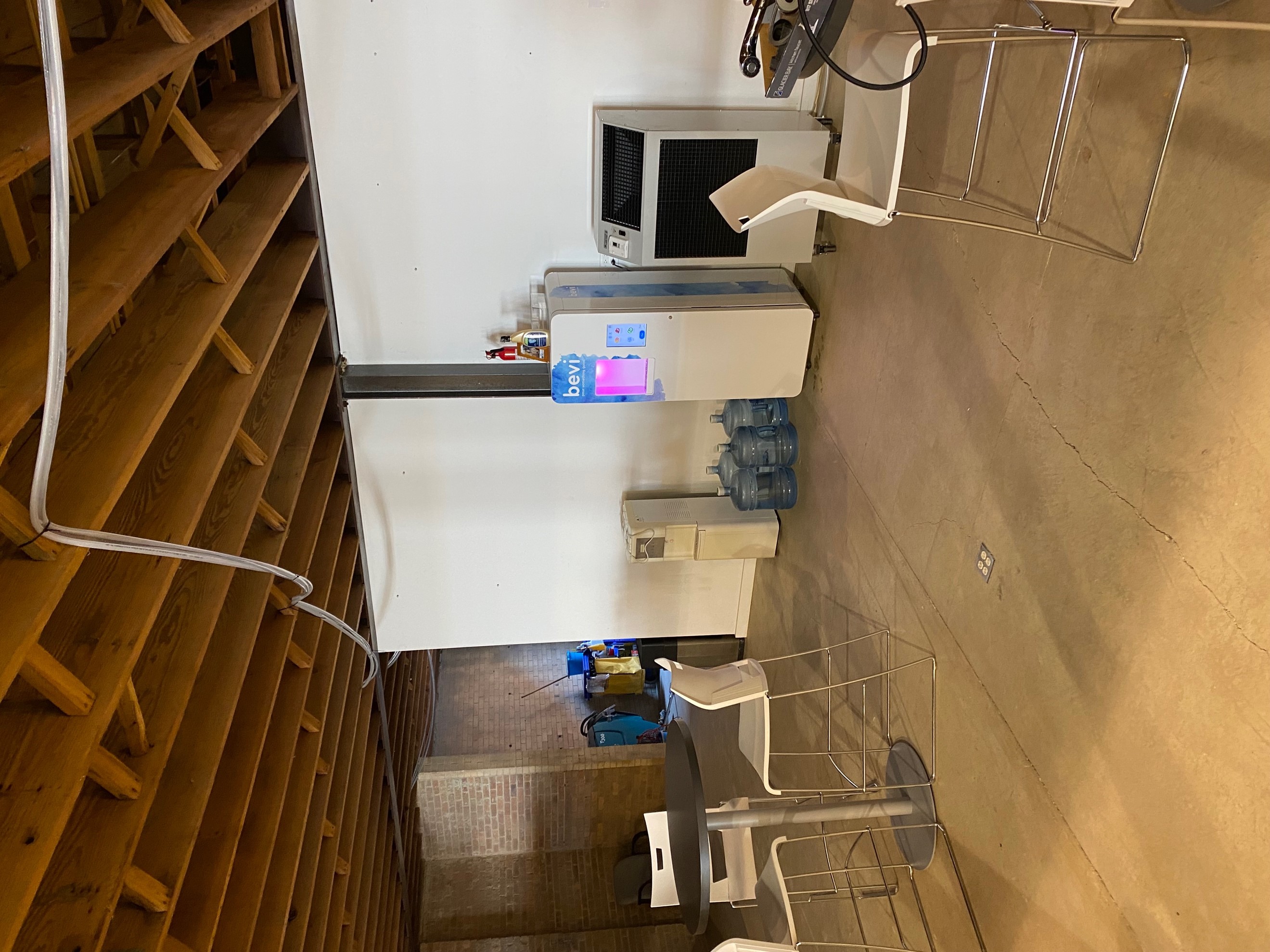 A larger temporary AC rental in the cafeteria area of the temporary office space with water hosing routed overhead. 